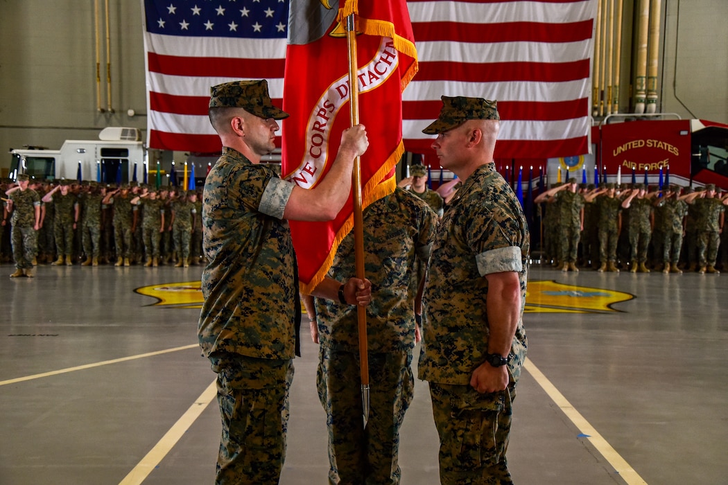 U.S. Marine Corps Lt. Col. Brian Meade, incoming Marine Corps Detachment Goodfellow commander, receives the detachment colors from Lt. Col. Thomas Coyle, outgoing MCD Goodfellow commander, during the change of command ceremony at the Louis F. Garland Department of Defense Fire Academy, Goodfellow Air Force Base, Texas, June 18, 2024. Coyle relinquished his duties as commander of MCD Goodfellow to Meade after commanding for two years. (U.S. Marine Corps photo by Cpl. Jessica Roeder)