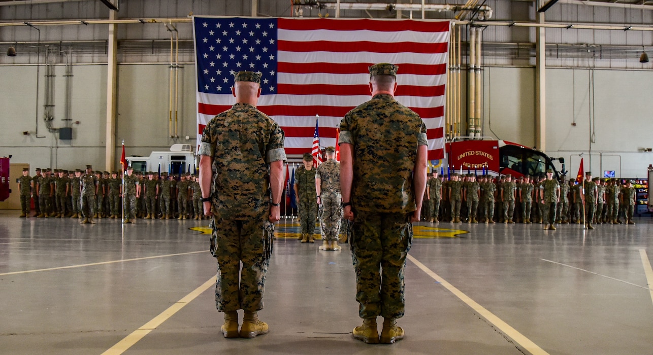 U.S. Marine Corps Lt. Col. Thomas Coyle, outgoing MCD Goodfellow commander (left), and Lt. Col. Brian Meade, incoming Marine Corps Detachment Goodfellow commander (right), stand at attention after the passing of the colors during the change of command ceremony at the Louis F. Garland Department of Defense Fire Academy, Goodfellow Air Force Base, Texas, June 18, 2024. The change of command ceremony represents the official passing of authority from the outgoing commander to the incoming commander. (U.S. Marine Corps photo by Cpl. Jessica Roeder)