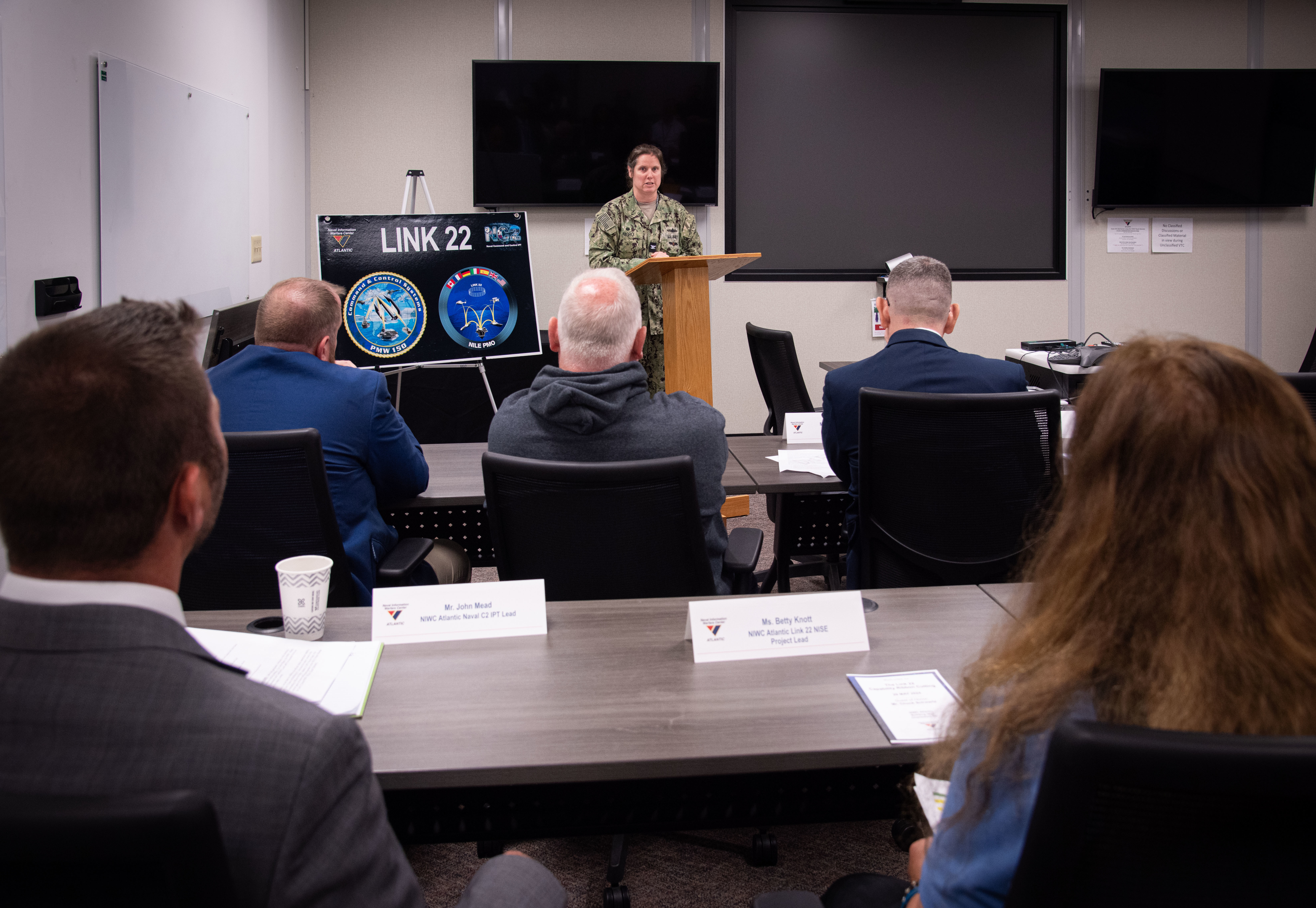 Captain Nicole Nigro, commanding officer, Naval Information Warfare Center (NIWC) Atlantic gives opening remarks at the opening of the Link 22 Lab. This new lab gives NIWC Atlantic the advantage of being able to air test live and to provide the warfighter with the necessary tools to communicate worldwide.