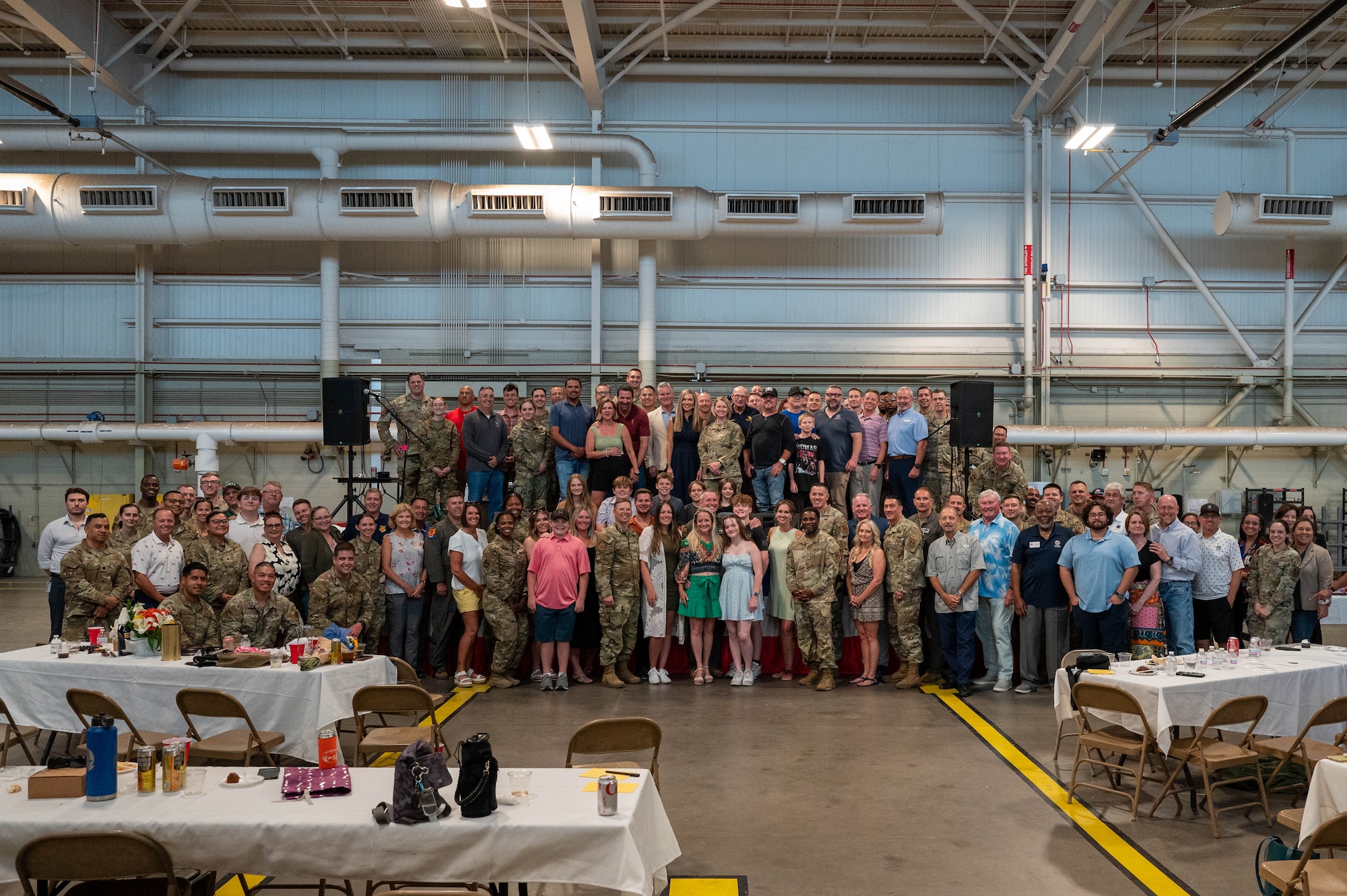U.S. Air Force Brig. Gen. Jason Rueschhoff (center), 56th Fighter Wing commander, stands alongside 56th FW group and squadron commanders and senior enlisted leaders as he is presented with a token of appreciation during an honorary commander farewell event, June 14, 2024, at Luke Air Force Base, Arizona.