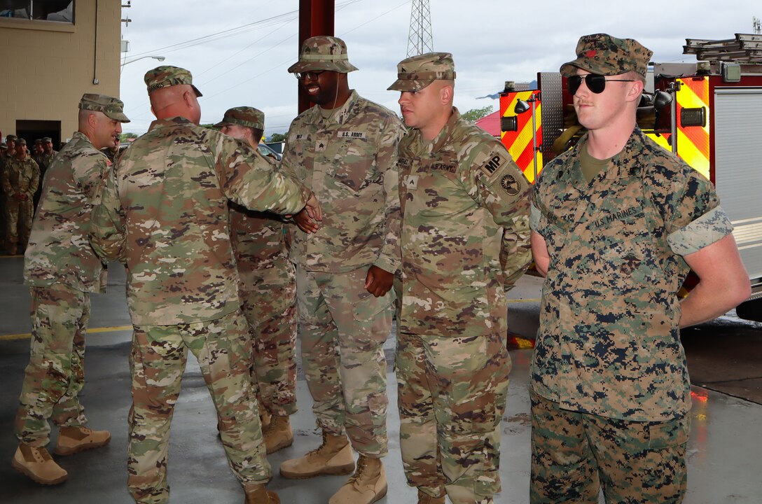 A photo of service members being coined.