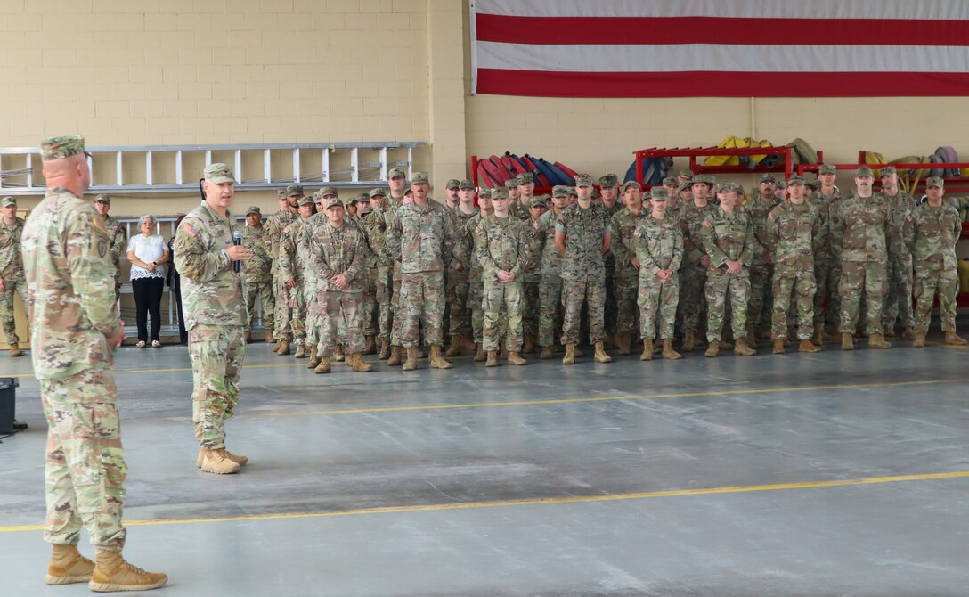 A photo of a Soldier talking to a crowd.