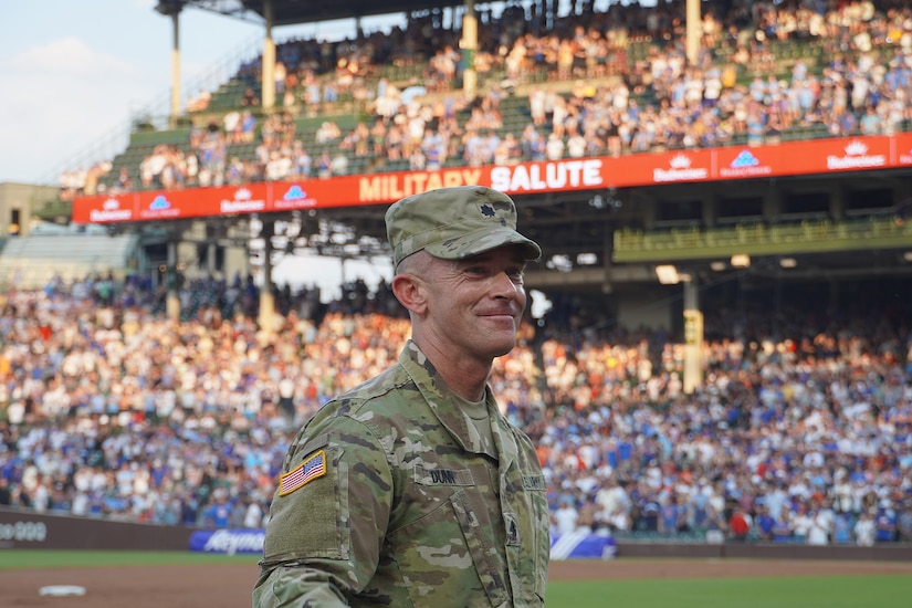 Lt. Col Brian Dunn, Public Affairs Officer, 85th U.S. Army Reserve Support Command, waves to cheering baseball fans during the Military Salute at the Chicago Cubs and San Francisco Giants game on June 17,2024, at Wrigley Field.