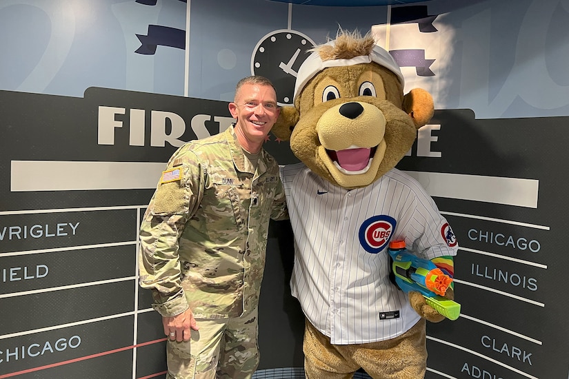 Lt. Col Brian Dunn, assigned to the 85th U.S. Army Reserve Support Command, pauses for a photo with Clark, the Chicago Cubs’ mascot, after a military recognition during a Chicago Cubs home game versus the San Francisco Giants, June 17,2024, at Wrigley Field.