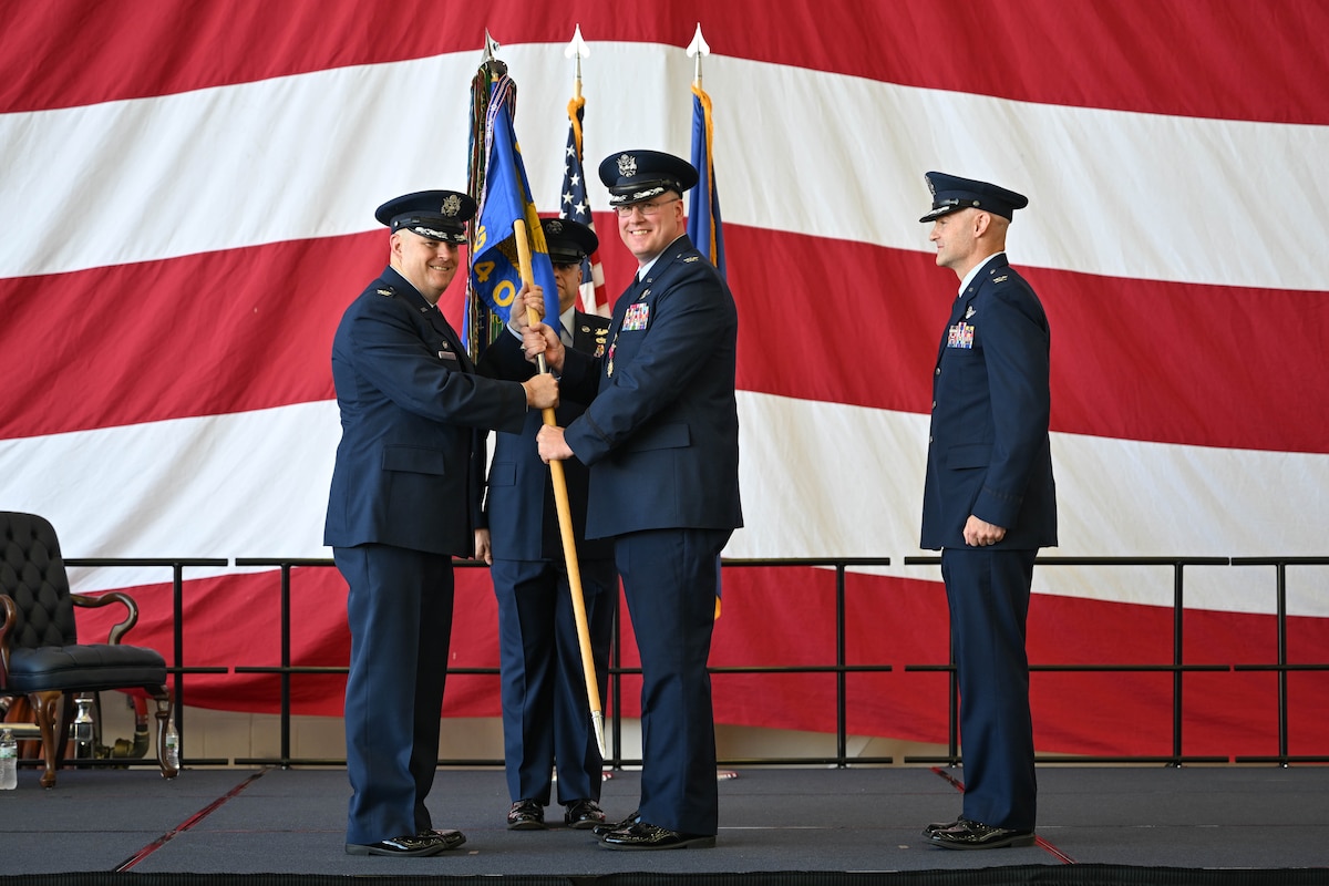Col. Jonathan Tucker, 314th Airlift Wing commander, receives the guidon from Col. Joseph Bonner, outgoing 314th Operations Group commander during a change of command ceremony at Little Rock Air Force Base, Arkansas, June 13, 2024. The passing of the guidon is a tradition symbolizing the transfer of leadership.