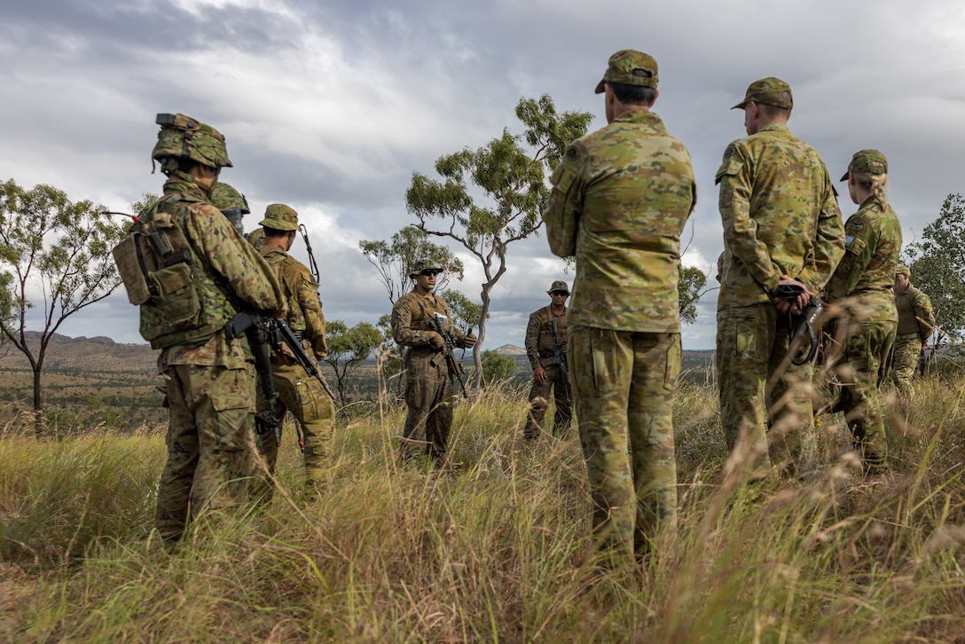 U.S. Marine Corps Capt. Shane Wescott, center, the company commander of Golf Company, 2nd Battalion, 5th Marine Regiment (Reinforced), Marine Rotational Force – Darwin 24.3, speaks with members of the Australian Defence Force during a visit by Australian Army General Angus Campbell, the chief of the ADF, and Lieutenant General Simon Stuart, the chief of the Australian Army, during Exercise Southern Jackaroo 24 at Townsville Field Training Area, Queensland, Australia, May 29, 2024. Members of MRF-D 24.3 deployed to TFTA to participate in Exercise Southern Jackaroo 24, a multilateral combined arms exercise held with capabilities and personnel from the Australian Army, U.S. Army and Marine Corps, Papua New Guinea Defence Force, and the Japanese Ground Self-Defense Force to increase interoperability with Allies and partners. Wescott is a native of Massachusetts. (U.S. Marine Corps photo by Cpl. Earik Barton)