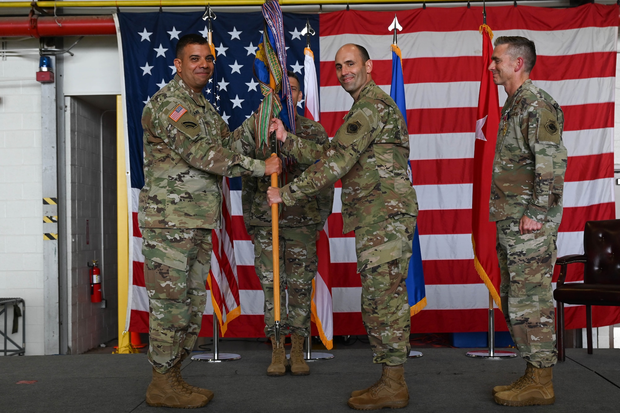 Col. Matthew McDonough, center right, incoming commander, District of Columbia Air National Guard, assumes command and receives the guidon from U.S. Army Maj. Gen. John C. Andonie