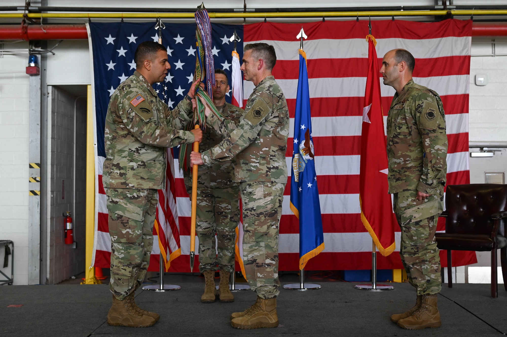 Brig. Gen. Shannon D. Smith, center right, outgoing commander, District of Columbia Air National Guard, relinquishes command and gives the guidon to U.S. Army Maj. Gen. John C. Andonie