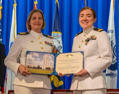 240607-N-JC800-1127 BETHESDA, Md. (Jun. 7, 2024) – Capt. Katharne Shobe, commanding officer of Naval Medical Leader and Professional Development Command, awards Lt. Julia Collazo with the Navy and Marine Corps Acheivement Medal during the graduation ceremony for the Naval Postgraduate Dental School. (U.S. Navy photo by Mass Communication Specialist 1st Class Heath Zeigler/Released)