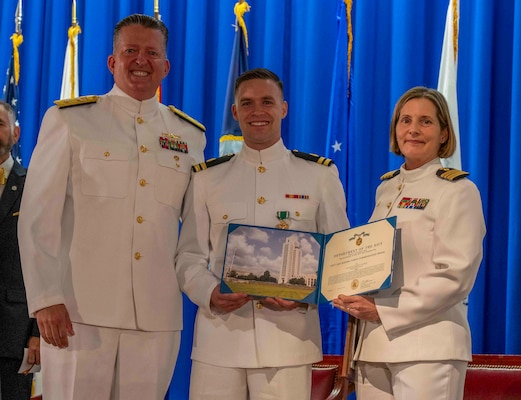 240607-N-JC800-1142 BETHESDA, Md. (Jun. 7, 2024) – Capt. Katharne Shobe, commanding officer of Naval Medical Leader and Professional Development Command, awards Lt. Timothy Daudelin with the Navy and Marine Corps Commendation Medal during the graduation ceremony for the Naval Postgraduate Dental School. (U.S. Navy photo by Mass Communication Specialist 1st Class Heath Zeigler/Released)