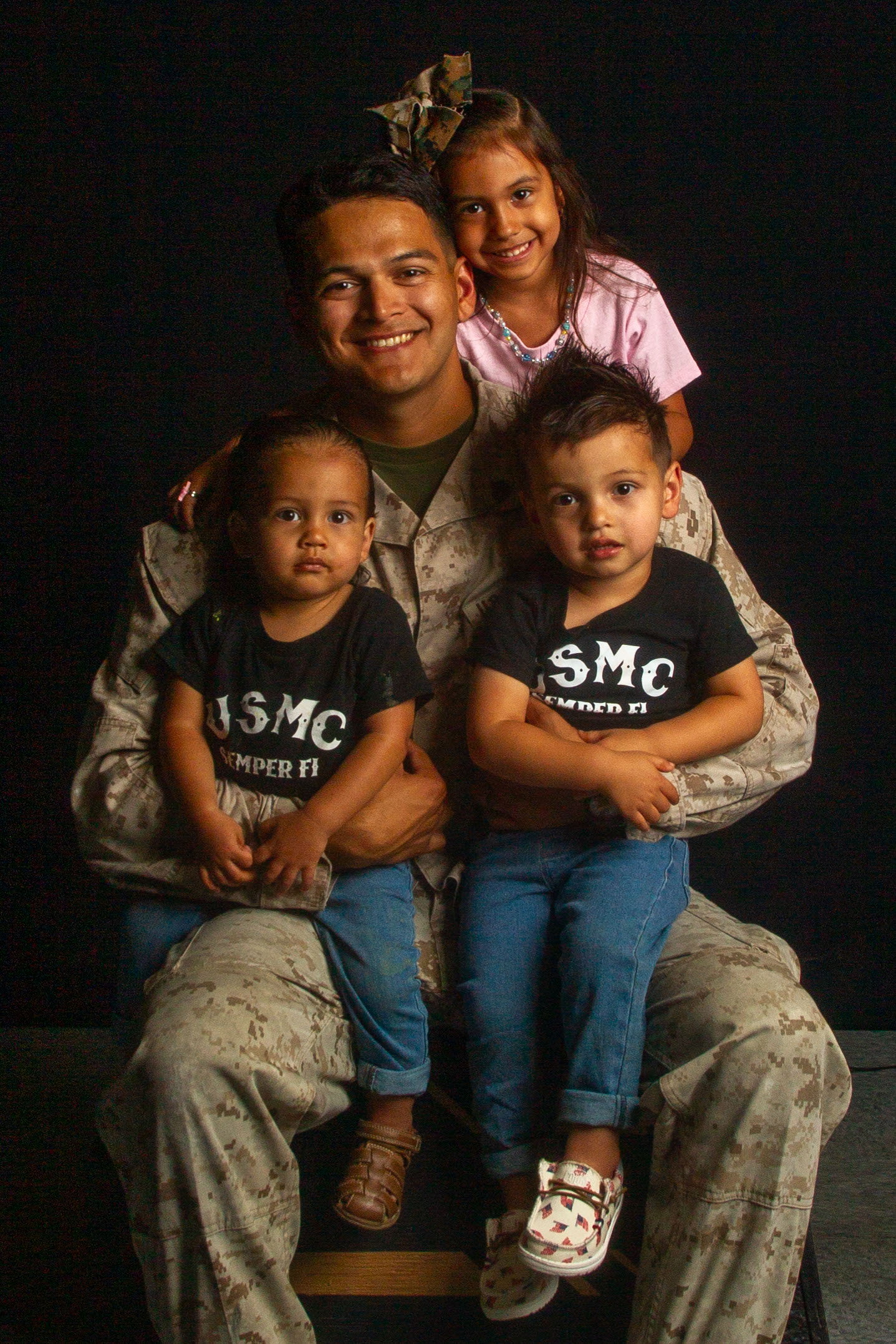 U.S. Marine Corps Sgt. Eduardxavi Napoliello, a Laporte, Texas native, transmission system operator instructor with Marine Corps Communication-Electronics School, Training Command, Training and Education Command, poses with his children during a Father’s Day photoshoot at Marine Corps Air-Ground Combat Center, Twentynine Palms, California, June 12, 2024. The Combat Center is dedicated to honoring and showing appreciation to active-duty fathers and father figures who not only are committed to serving their country but also their families. (U.S. Marine Corps photo by Lance Cpl. Anna Higman)