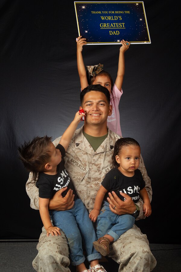 U.S. Marine Corps Sgt. Eduardxavi Napoliello, a Laporte, Texas native, transmission system operator instructor with Marine Corps Communication-Electronics School, Training Command, Training and Education Command, poses with his children during a Father’s Day photoshoot at Marine Corps Air-Ground Combat Center, Twentynine Palms, California, June 12, 2024. The Combat Center is dedicated to honoring and showing appreciation to active-duty fathers and father figures who not only are committed to serving their country but also their families. (U.S. Marine Corps photo by Lance Cpl. Anna Higman)