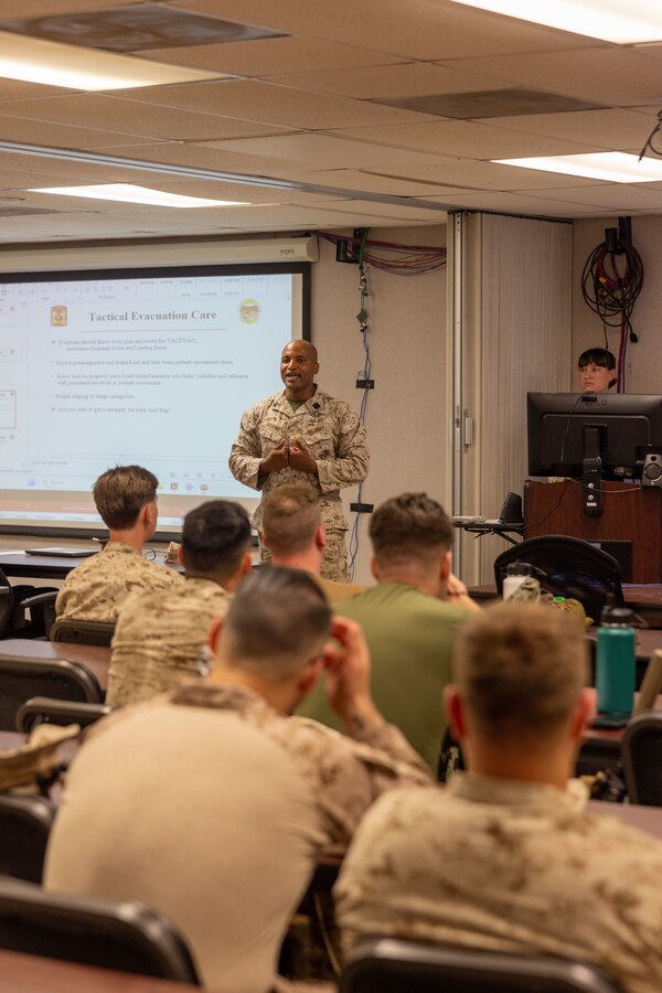 U.S. Navy Hospitalman 1st Class Derris Graham with Tactical Training and Exercise Control Group, Marine Air-Ground Task Force Training Command, Marine Corps Air-Ground Combat Center, give a tactical combat casualty care brief at MCAGCC, Twentynine Palms, California, June 13, 2024. TCCC ensures Marines are trained to properly preform medical procedures to prevent loss of life and ensure force preservation. ITX enables Marine Forces Reserve to mobilize geographically dispersed forces for potential future deployments, increase combat readiness and lethality, and exercise Marine Air-Ground Task Force command and control of battalions and squadrons across the full spectrum of warfare. (U.S. Marine Corps photo by Lance Cpl. Anna Higman)