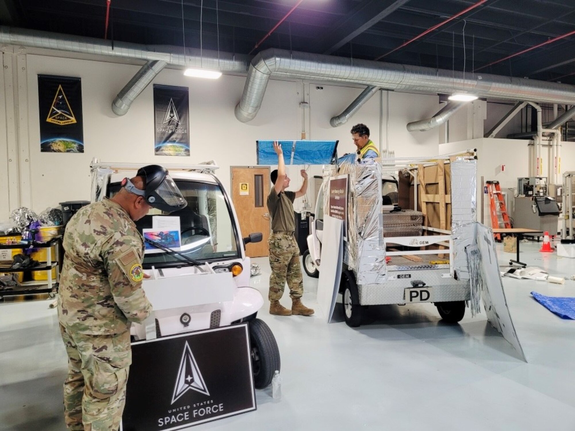 Tech. Sgt. Vincent Manabat, Sgt. Melvin Smith, and Mr. Dilver Funes (left to right) are shown building the USSF satellite floats at Los Angeles Air Force Base for the 62nd annual Torrance Armed Forces Day Parade and Celebration where the U.S. Space Force was the honored military branch. (U.S. Space Force courtesy photo)