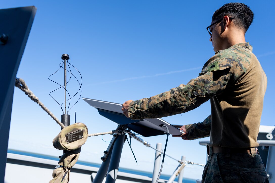 U.S. Marine Corps Cpl. Leonardo Mata, a satellite transmissions system operator with Marine Rotational Force – Darwin 24.3, sets up a Starshield aboard the HMAS Adelaide (L01), in the Arafura Sea, June 3, 2024. Marines and Sailors embarked on HMAS Adelaide (L01) alongside their Australian Allies to participate in the Wet and Dry Exercise Rehearsal, transiting from Darwin to Townsville from June 2-20, 2024. During WADER, elements from the MRF-D Marine Air-Ground Task Force will conduct MV-22B Osprey deck landing qualifications, a live-fire deck shoot, medical subject matter expert exchanges, enhance amphibious fires, command and control, and initiate a ship-to-shore movement in order to set conditions for future operational tasking. Mata is a native of California. (U.S. Marine Corps photo by Gunnery Sgt. Kassie McDole)