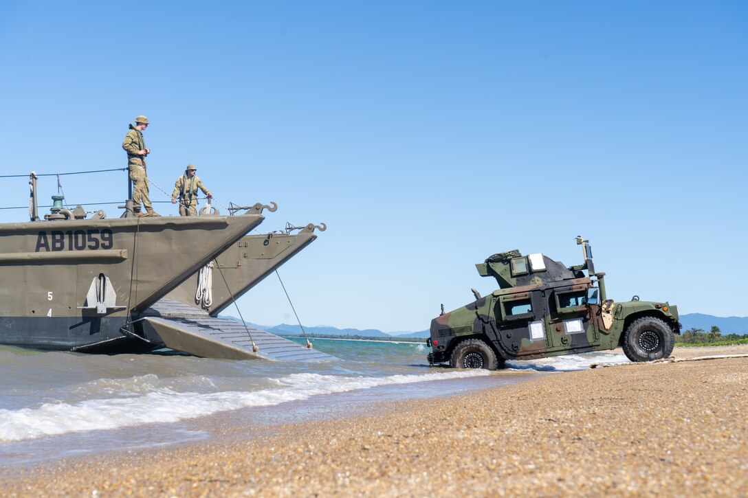 U.S. Marine Corps Cpl. Cody Albert, a motor transport operator with Combat Logistics Battalion 5 (Reinforced), Marine Rotational Force – Darwin 24.3, drives a HMMWV from a Royal Australian Navy Landing Craft assigned to HMAS Adelaide (L01) on to Cowley Beach for an amphibious ship-to-shore operation during the Wet and Dry Exercise Rehearsal at Cowley Beach Training Area, QLD, Australia, June 16, 2024. During WADER, elements from the MRF-D Marine Air-Ground Task Force will conduct MV-22B Osprey deck landing qualifications, a live-fire deck shoot, medical subject matter expert exchanges, enhance amphibious fires, command and control, and initiate a ship-to-shore movement in order to set conditions for future operational tasking. Albert is a native of Texas. (U.S. Marine Corps photo by Gunnery Sgt. Kassie McDole)