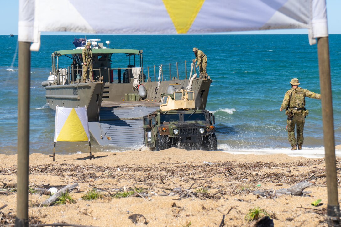U.S. Marine Corps Lance Cpl. Josue RobleroGonzalez, a motor transport operator with Combat Logistics Battalion 5 (Reinforced), Marine Rotational Force – Darwin 24.3, drives a HMMWV from a Royal Australian Navy Landing Craft assigned to HMAS Adelaide (L01) on to Cowley Beach for an amphibious ship-to-shore operation during the Wet and Dry Exercise Rehearsal at Cowley Beach Training Area, QLD, Australia, June 16, 2024. During WADER, elements from the MRF-D Marine Air-Ground Task Force will conduct MV-22B Osprey deck landing qualifications, a live-fire deck shoot, medical subject matter expert exchanges, enhance amphibious fires, command and control, and initiate a ship-to-shore movement in order to set conditions for future operational tasking. RobleroGonzalez is a native of North Carolina. (U.S. Marine Corps photo by Gunnery Sgt. Kassie McDole)