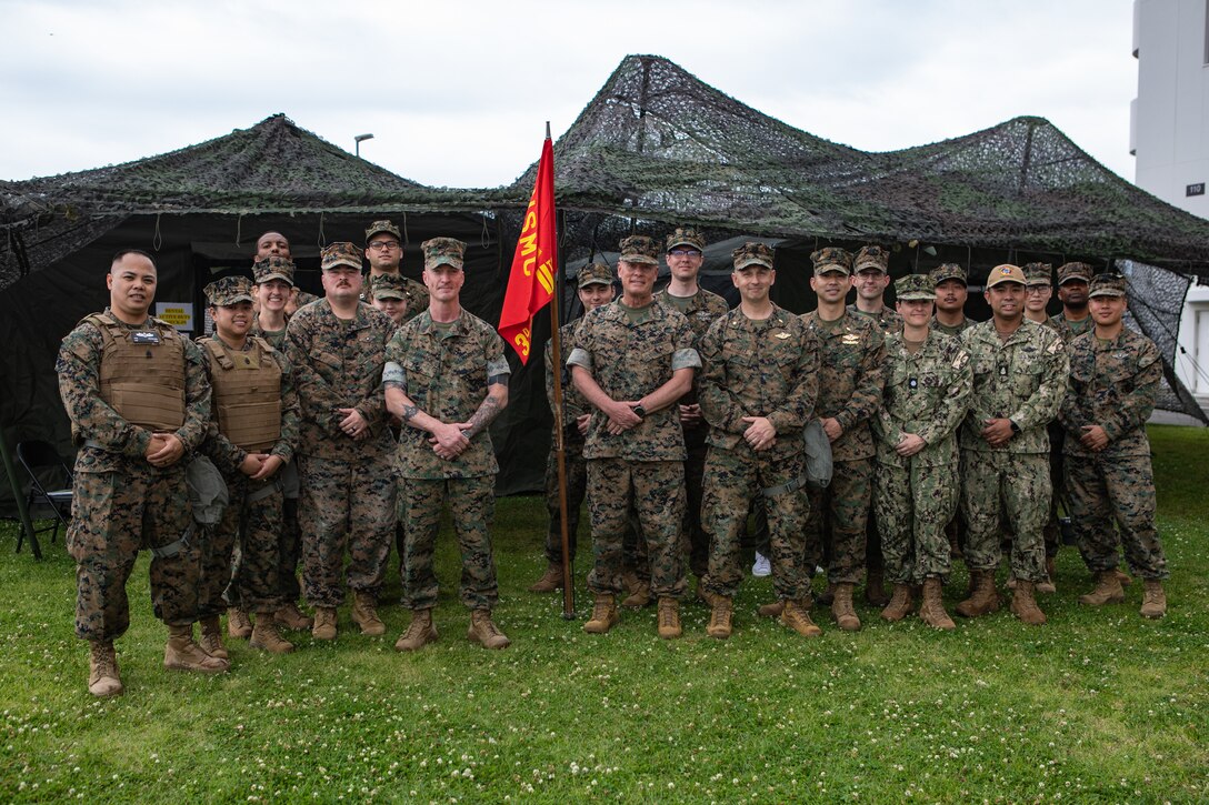 Leaders from Marine Corps Installations and 3rd Dental Battalion, 3rd Marine Logistics Group, III Marine Expeditionary Force’s bi-annual field training exercise Shika-X 24.2 pose for a group photo during dental field exercise Shika-X at Marine Corps Air Station Iwakuni, Japan, June 10, 2024. Shika-X is a biannual field training exercise designed to test their operational limits while in a field environment. (U.S. Marine Corps photo by Lance Cpl. Dahkareo Pritchett)
