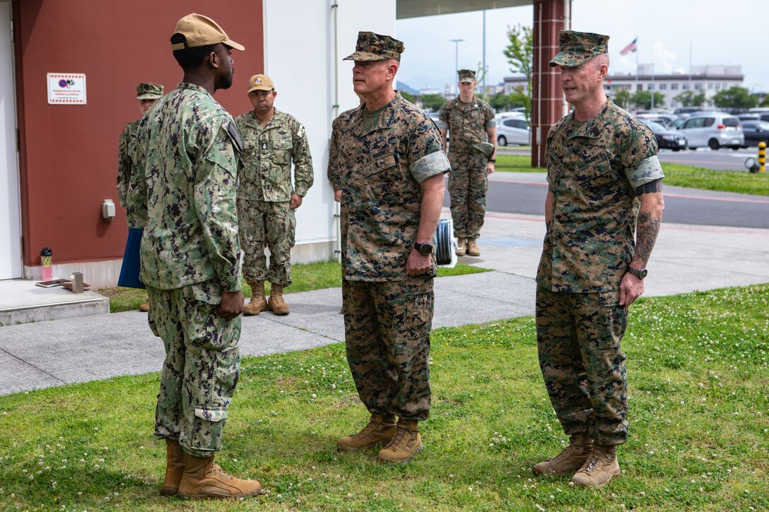 U.S. Navy Hospitalman Oddison White, assigned to Naval Family Branch Clinic Iwakuni, and a native of California, receives the Marine Corps Installations Command Life Saving award from U.S. Marine Corps Maj. Gen. David Maxwell, the commanding general of MCICOM, and a native of Oregon, during an award ceremony at Marine Corps Air Station Iwakuni, Japan, June 10, 2024. Hospitalman Oddison White was awarded the MCICOM life-saving award for immediately responding to an incident requiring emergency medical service where he provided lifesaving resuscitation that directly contributed to the patient surviving. (U.S. Marine Corps photo by Lance Cpl. Dahkareo Pritchett)