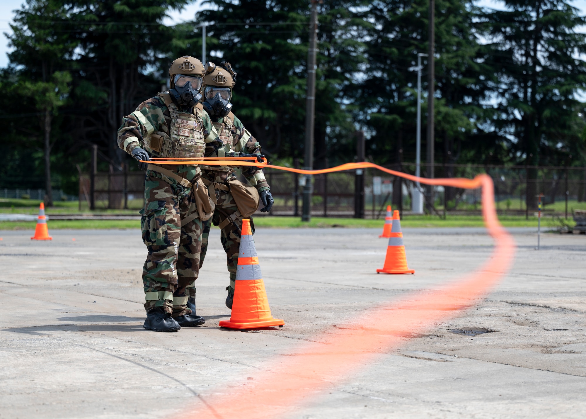 Emergency management journeymen cordon off a simulated contaminated area.