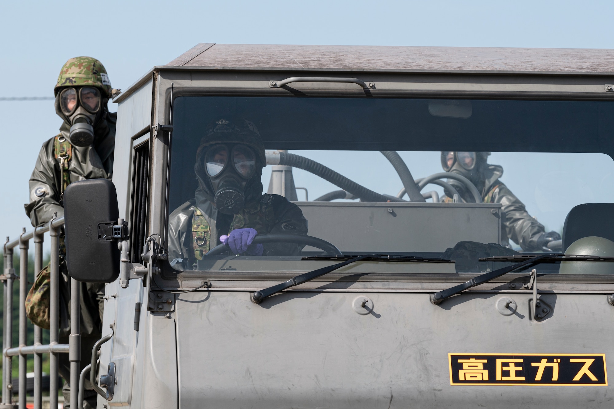 Members of the Japan Ground Self-Defense Force prepare to conduct a decontamination demonstration with a type three decontamination vehicle.