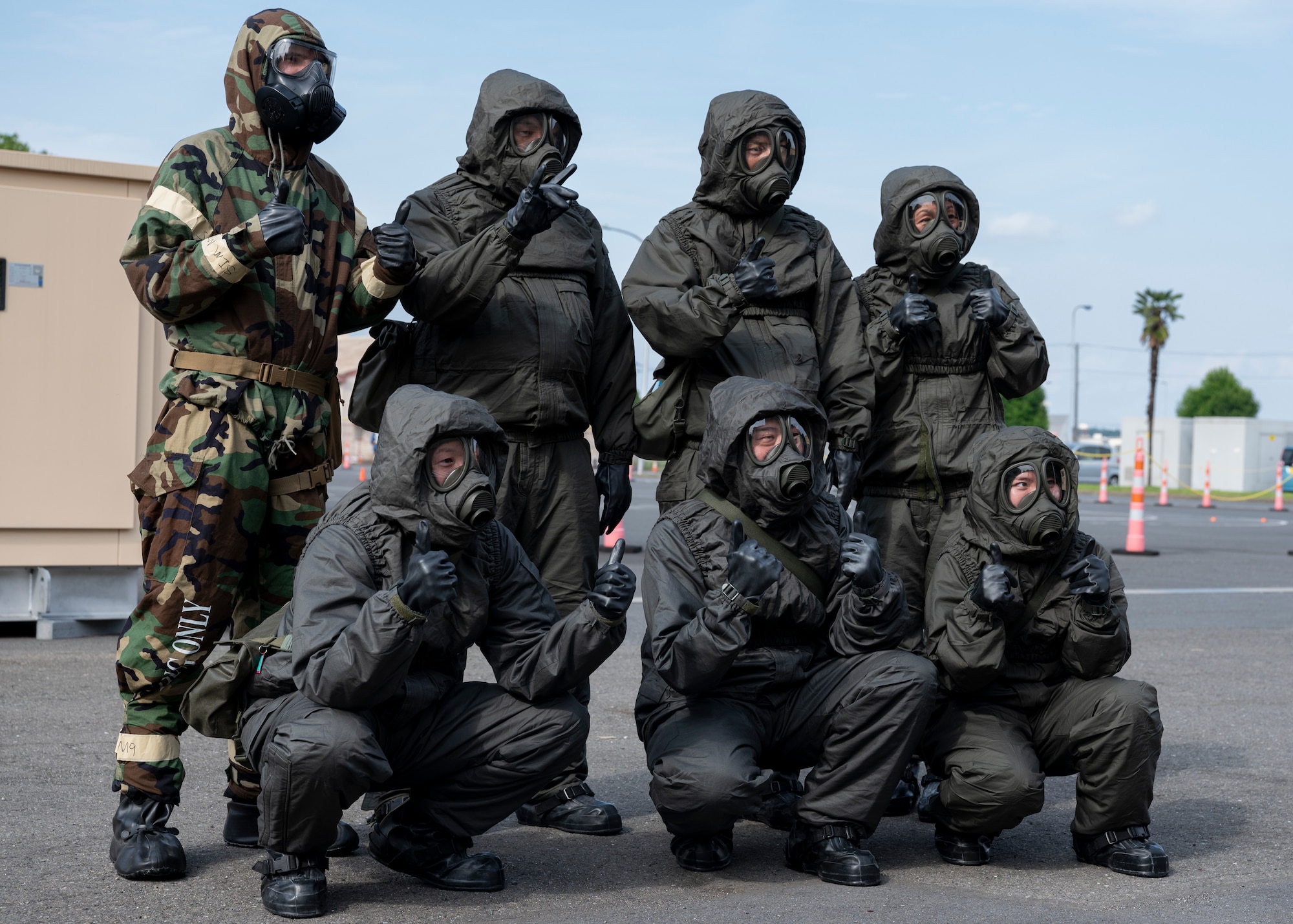 A U.S. Air Force airman and Japan Air Self-Defense Force members pose for a photo.