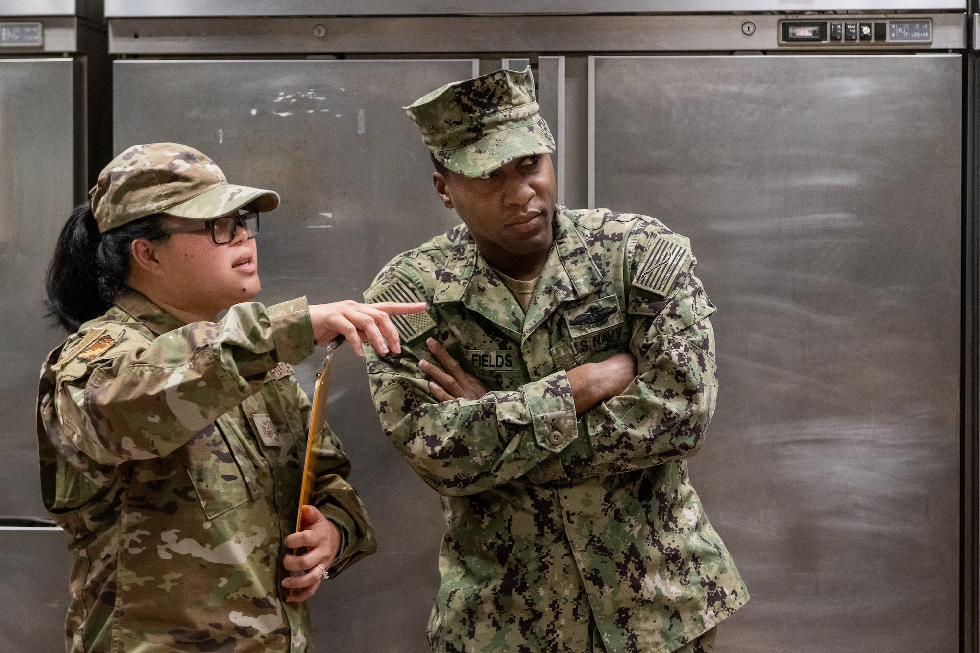 Tech. Sgt. Alexandria Fernando, public health technician, 126th Medical Group, 126 Air Refueling Wing Scott Air Force Base, Illinois, and U.S. Navy Petty Officer William Fields, preventive medicine corpsman, U.S. Naval Hospital in Naples Italy, discussion inspection of the Navy exchange food court restaurants in Capodichino, Italy, June 5, 2024.