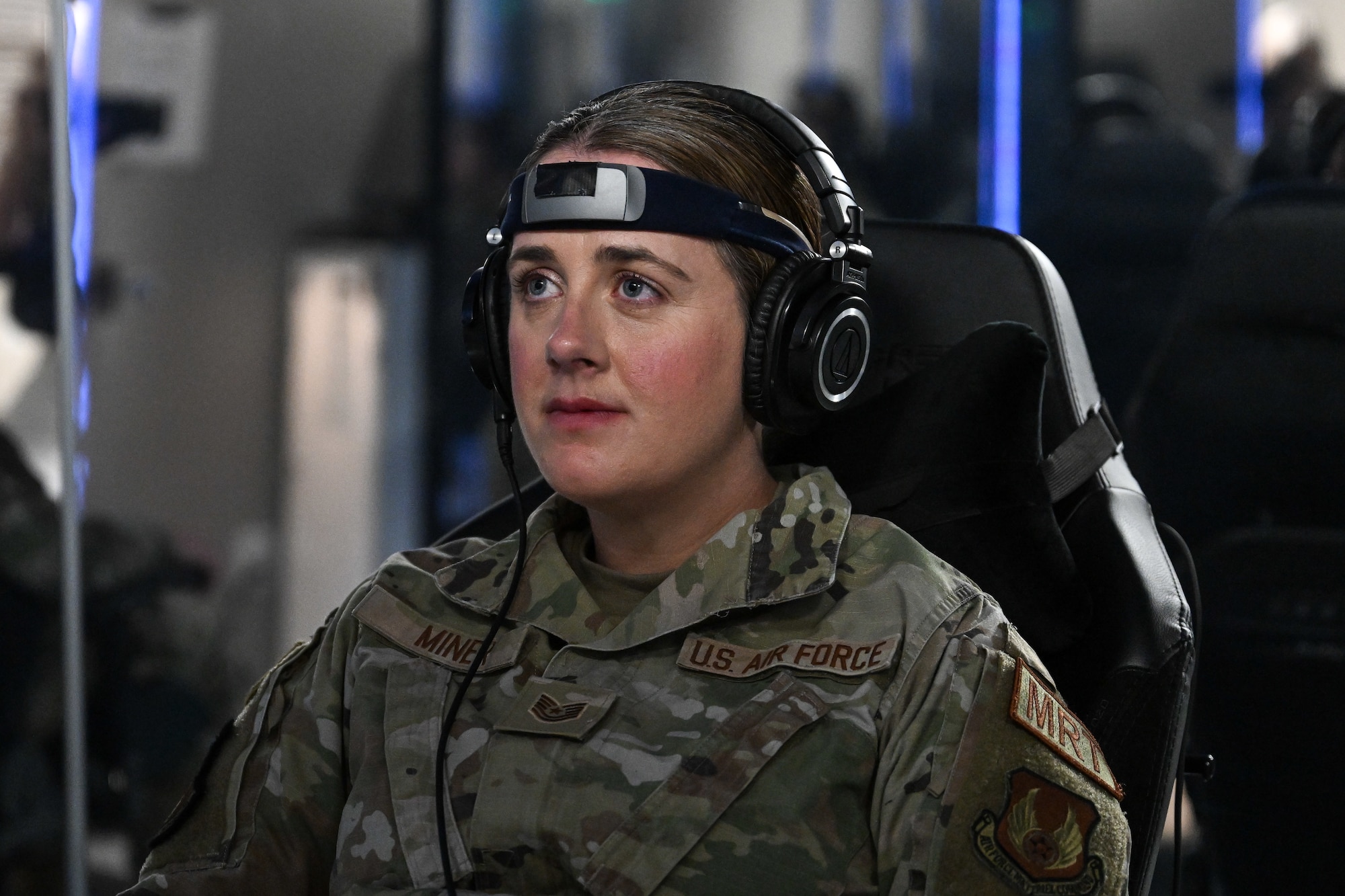 An Airman sits in a sensory deprivation pod surrounded by reflective mirrors