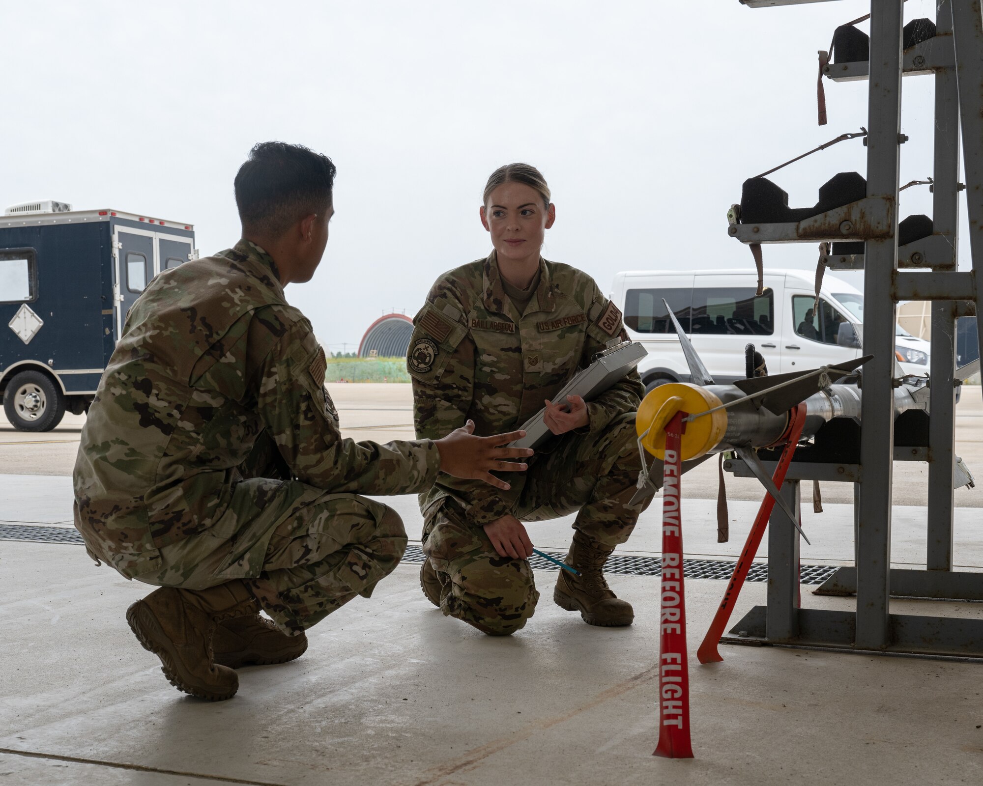 Senior Airman Marcos Garay, left, 80th Fighter Generation Squadron weapons team member, and U.S. Air Force Tech. Sgt. Danielle Baillargeon, right, 80th FGS weapons team chief, inspect munitions at Kunsan Air Base, Republic of Korea.