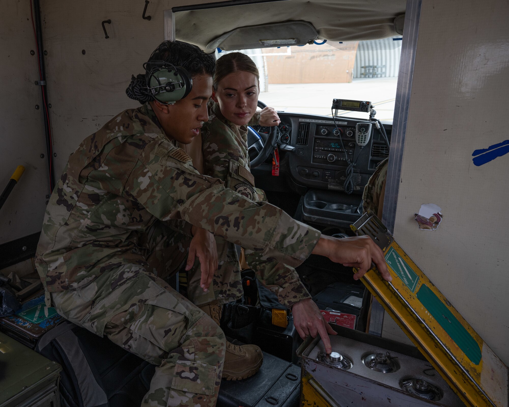 U.S. Air Force Tech. Sgt. Danielle Baillargeon, 80th Fighter Generation Squadron weapons team chief, instructs Senior Airman Marcos Garay, 80th FGS weapons crew member, on changing argon canisters at Kunsan Air Base, Republic of Korea.