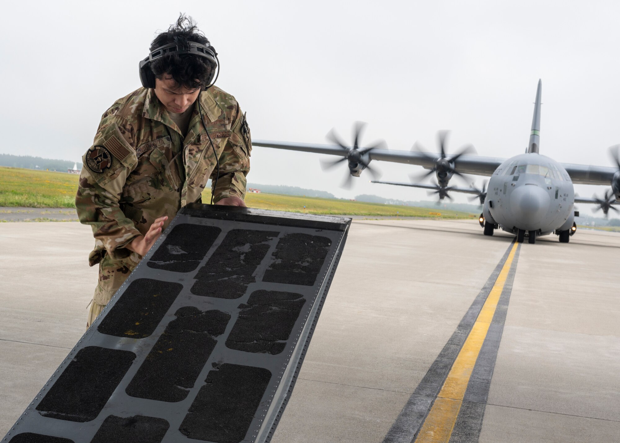 An airman raises the loading dock of C-130J Super Hercules.