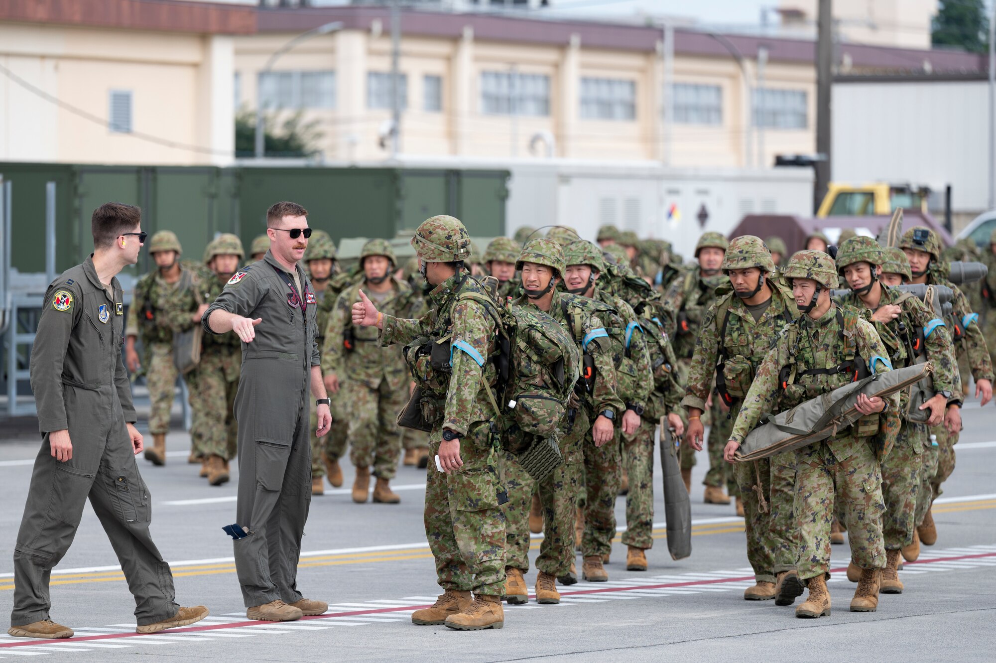 U.S. Air Force airmen talk to members of the Japan Ground Self-Defense Force assigned to the 1st Airborne Brigade.