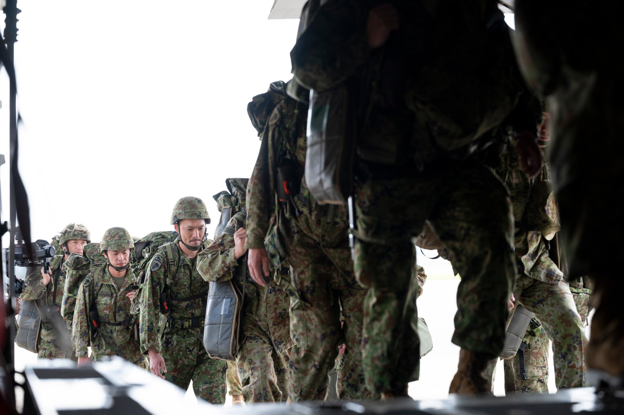 Japan Ground Self-Defense Force paratroopers assigned to the 1st Airborne Brigade board a U.S. Air National Guard C-130J Super Hercules.
