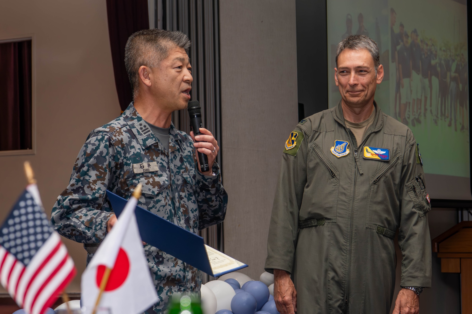 Japan Air Self-Defense Force Col. Hiroyuki Ishii, Operations Support Wing commander, left, presents a letter of appreciation.