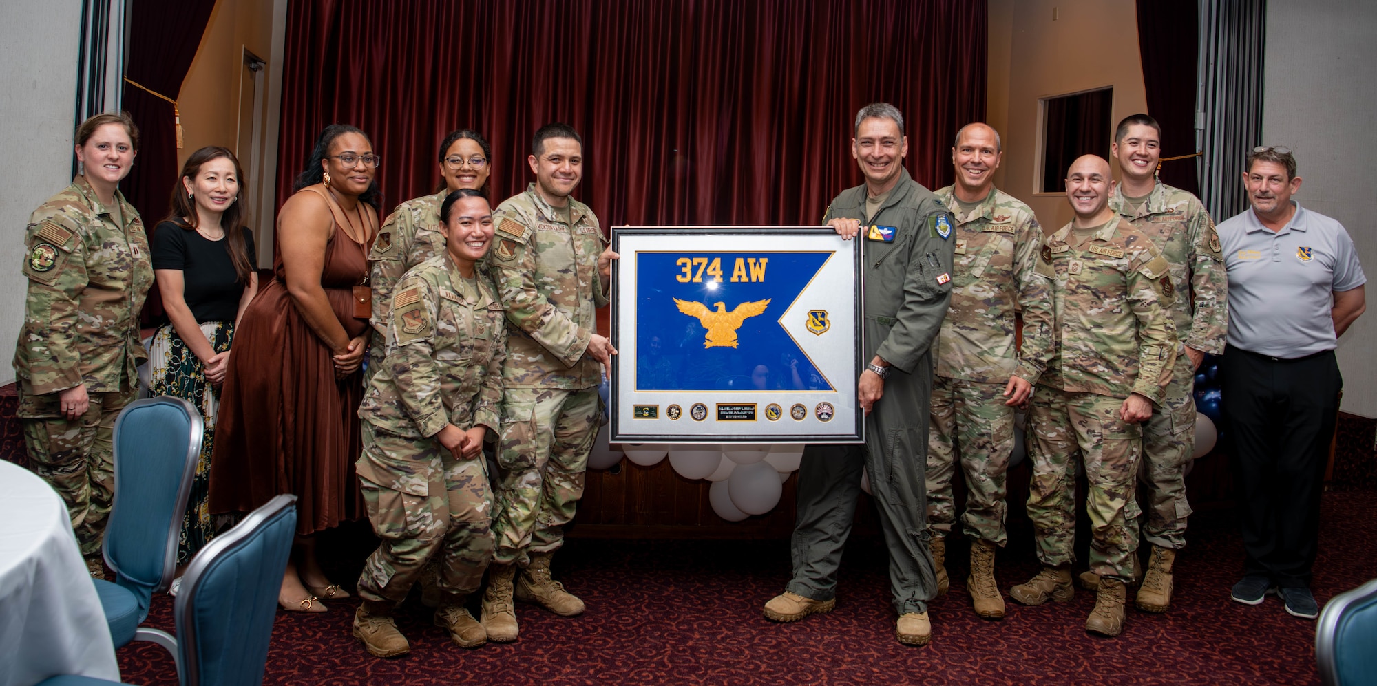 Members of the 374th Airlift Wing pose for a group photo.