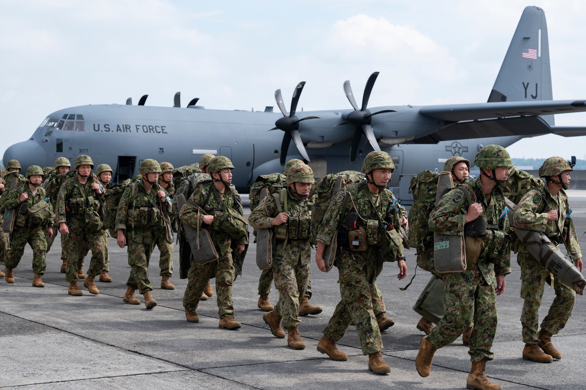 Japan Ground Self-Defense Force paratroopers assigned to the 1st Airborne Brigade prepare to board U.S. Air Force C-130J Super Hercules assigned to the 36th Airlift Squadron.