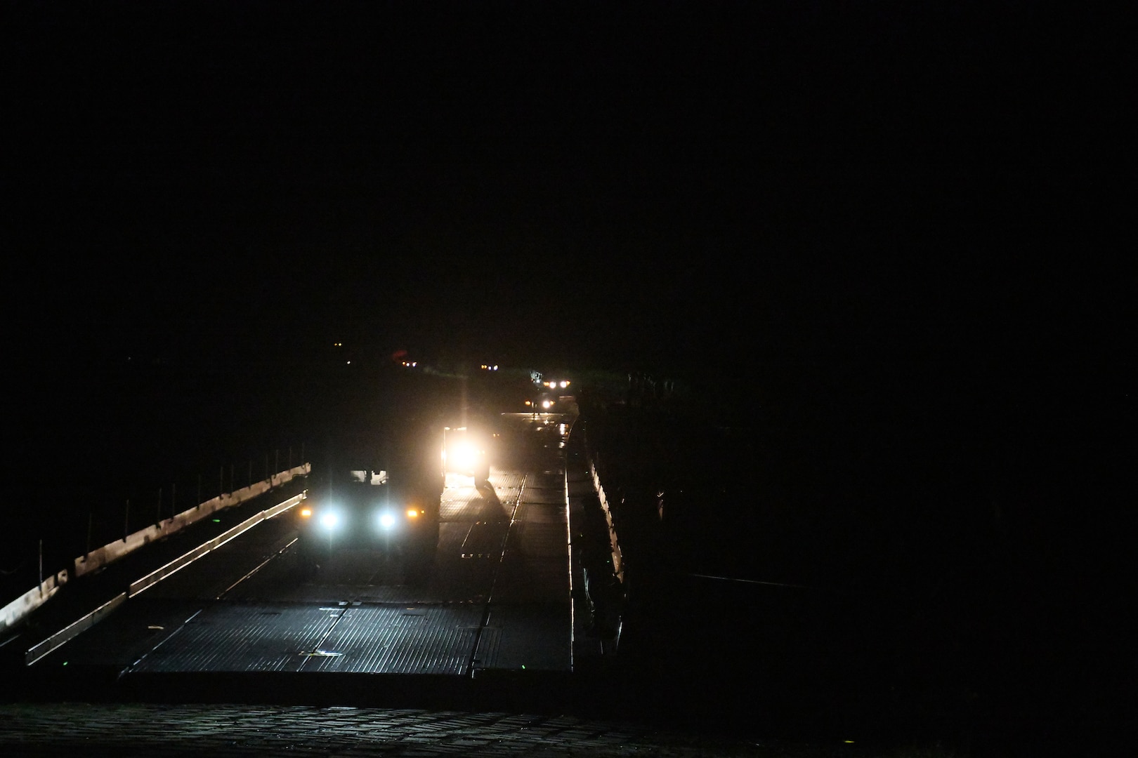 Michigan National Guard Engineers of the 1437th Multi-Role Bridge Company worked through the night to unload trucks carrying boats and bridge sections and successfully pieced together a bridge across the Mississippi River during training on Camp Ripley, Minnesota, June 11, 2024.