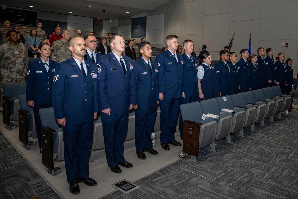 A group of Airmen stand at attention during a ceremony