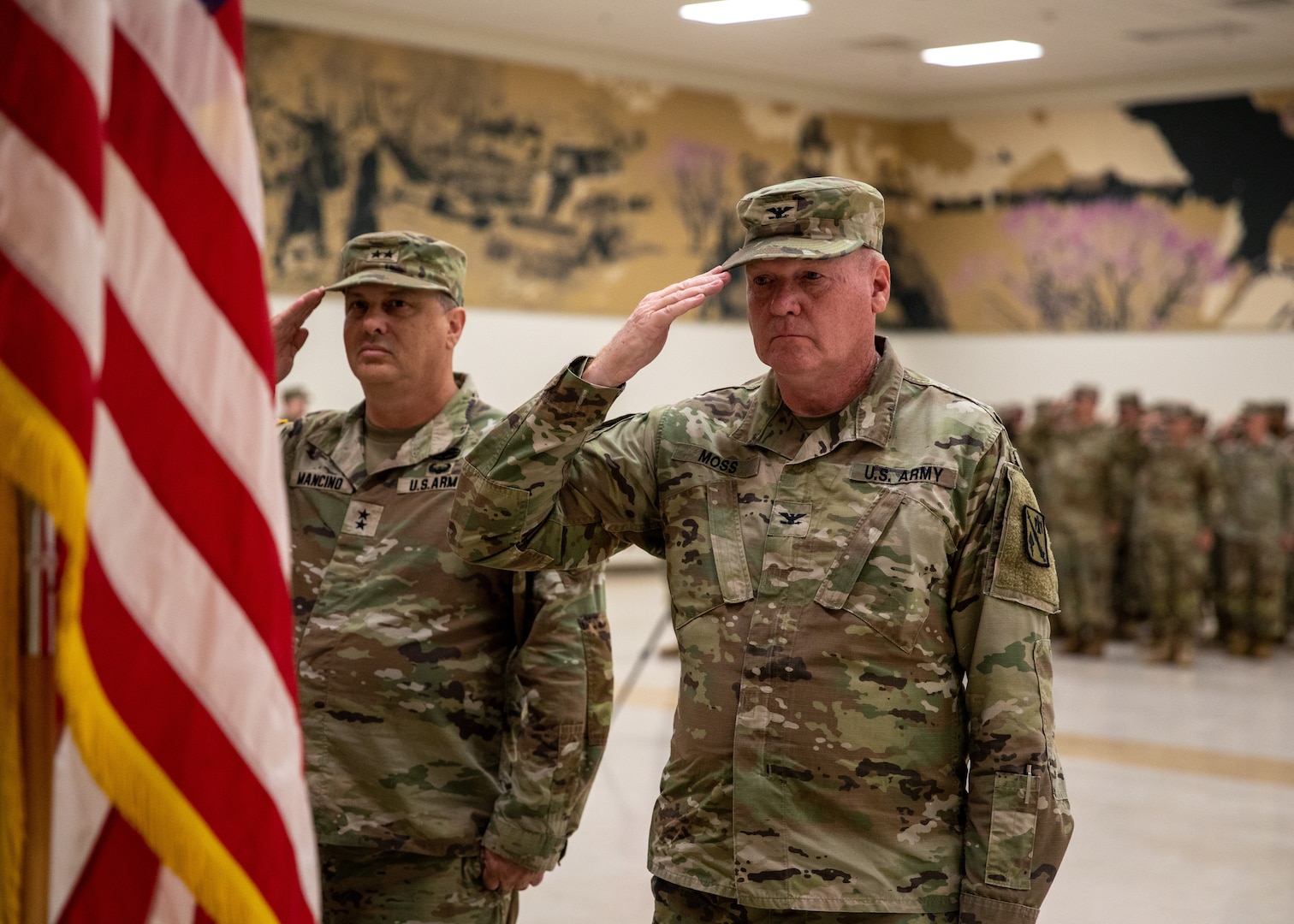 Col. Johnnie Dale Moss, outgoing commander of the 45th Field Artillery Brigade, Oklahoma Army National Guard, and Maj. Gen. Thomas H. Mancino, adjutant general for Oklahoma, salute for the playing of the National Anthem during a change of command ceremony held at the Mustang Armed Forces Reserve Center in Mustang, Oklahoma, on June 15, 2024. The changing of command signifies the transfer of responsibility from outgoing commander Moss, to incoming commander Lt. Col. Rogers. (Oklahoma National Guard photo by Pfc. Brooklyn Clark)