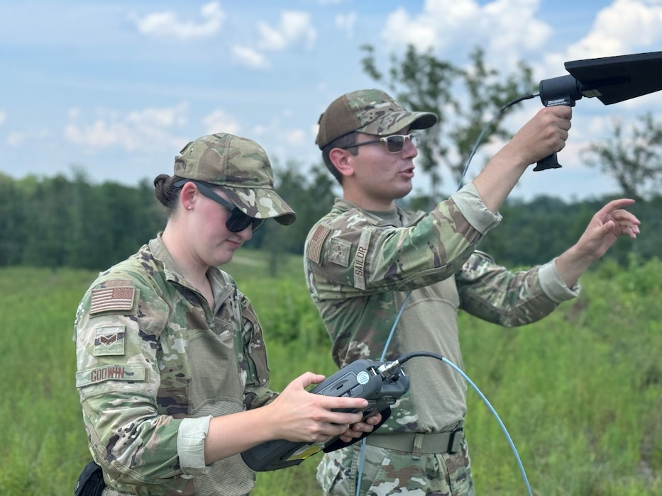 U.S. Airmen assigned to the 85th Engineering Installation Squadron work with radio equipment.