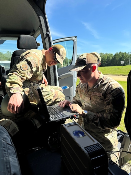 U.S. Air Force members assigned to the 85th Engineering Installation Squadron work on computer.