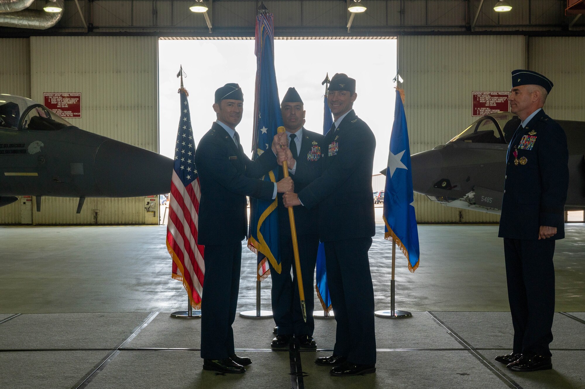 man hands guidon to man