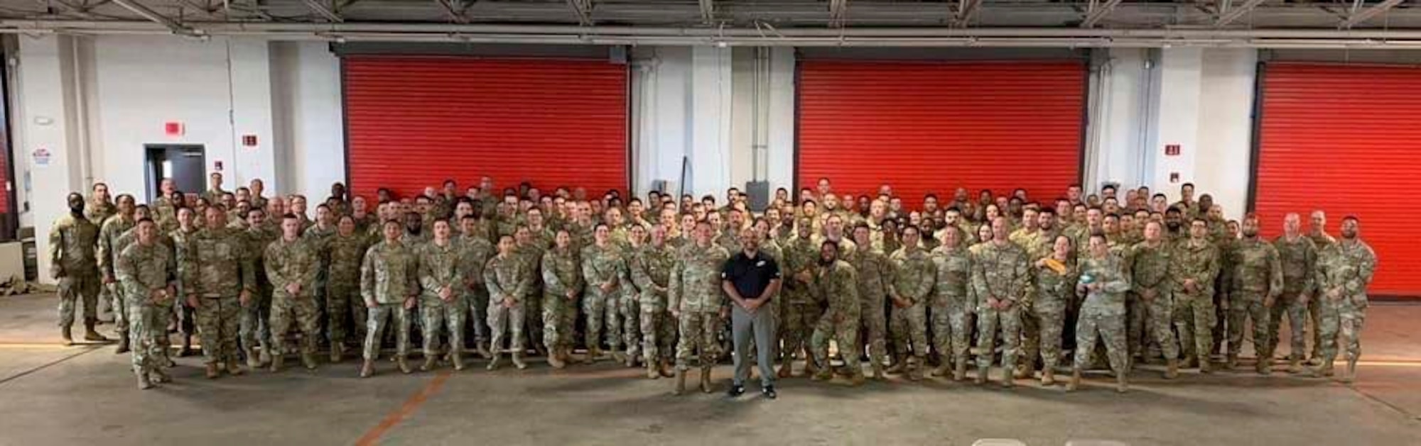Coach Jamal Singleton, Philadelphia Eagles assistant coach, poses for a photo with 621st Contingency Response Wing Airmen June 10, 2024, at Joint Base McGuire-Dix-Lakehurst, N.J.