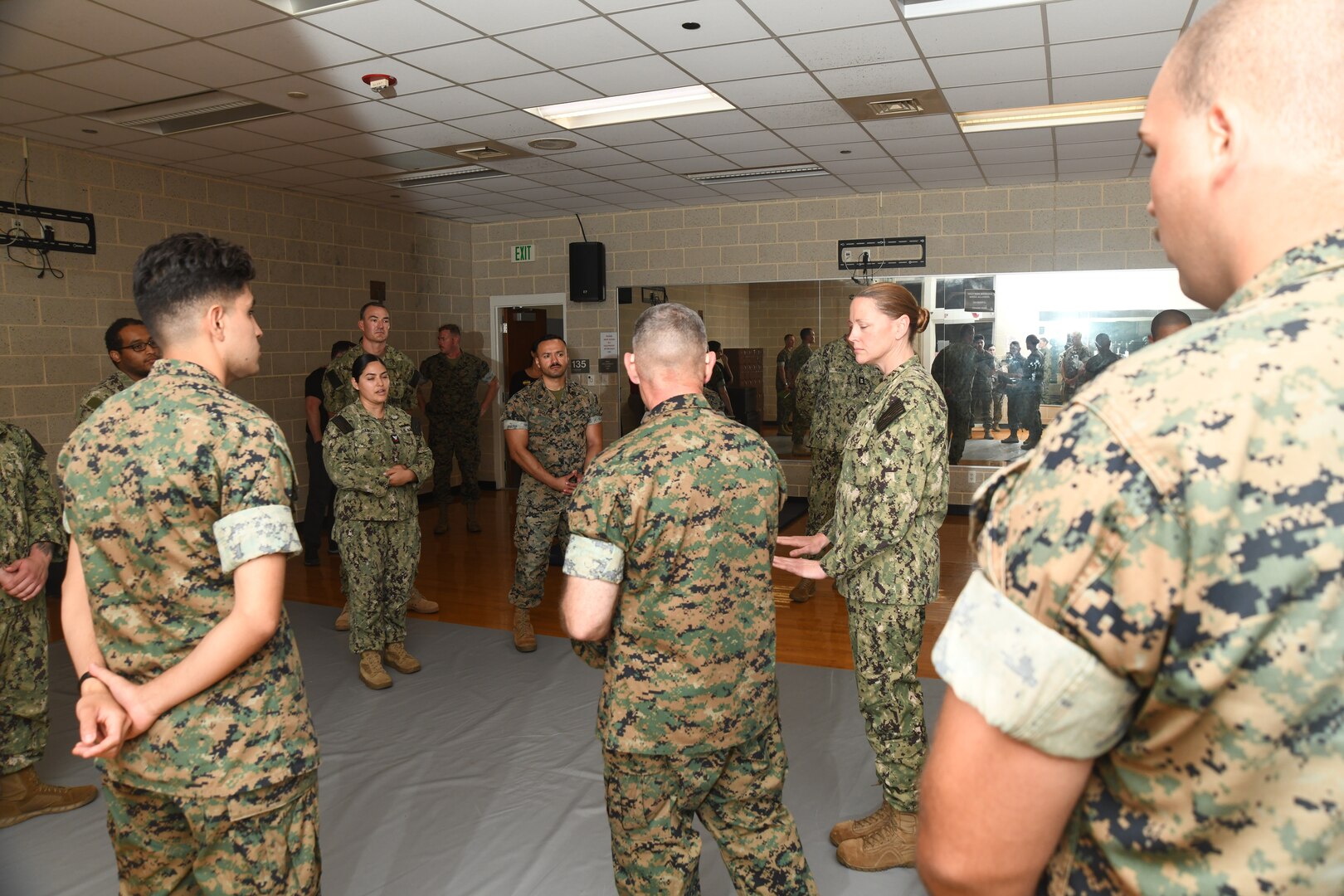 Capt. Anja Dabelić, Naval Medical Center Camp Lejeune commander and director, and Col. Ralph Rizzo, Marine Corps Installations East acting commander, addresses safety protocol for patients placed in isolation during the extreme weather exercise at Wallace Creek Fitness Center, aboard Marine Corps Base Camp Lejeune on June 12, 2024. The extreme weather exercise was a joint training exercise to ensure efficient medical care is provided in the event of severe weather.