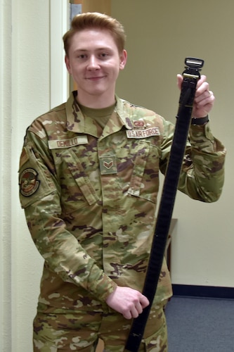 An Airman stands with a belt.