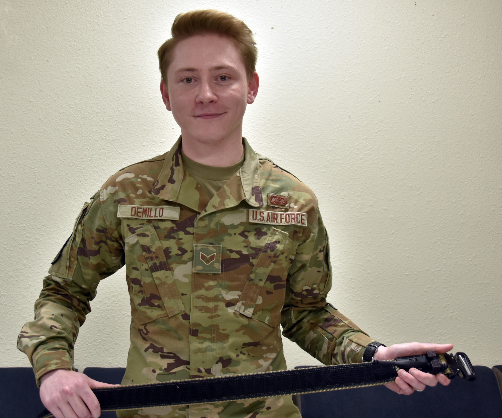 An Airman holds a belt