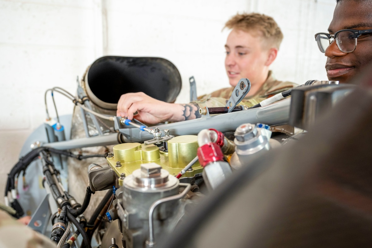 U.S. Air Force Airmen 1st Class Kennedy Richardson, left, and Justin Dacosta, 29th Aircraft Maintenance Unit avionics technicians, inspect turboprop engine lines for leaks at Holloman Air Force Base, New Mexico, June 14, 2024. The Multi-Capable Airmen training program grants Airmen the opportunity to receive full certification, allowing them to specialize in avionics, crew chief and weapons training. (U.S. Air Force photo by Airman 1st Class Michelle Ferrari)