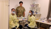 U.S. Army Capt. Lee Brethower, a general dentist, along with Spc. Yadir Blas and Spc. Ximena Lopez, both dental assistants, all assigned to the 673rd Dental Company Area Support, take a photo after setting up their dental station at the joint aid station as part of their responsibilities at Mihail Kogălniceanu Air Base, Romania, June 20, 2024. The mission of the United States Dental Command is to deliver global dental services that enable sustained readiness for the total force. (U.S. Army photo by Spc. Joshua Maxie)