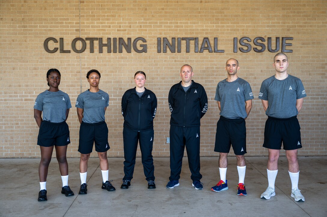 men and women line up wearing physical training uniform