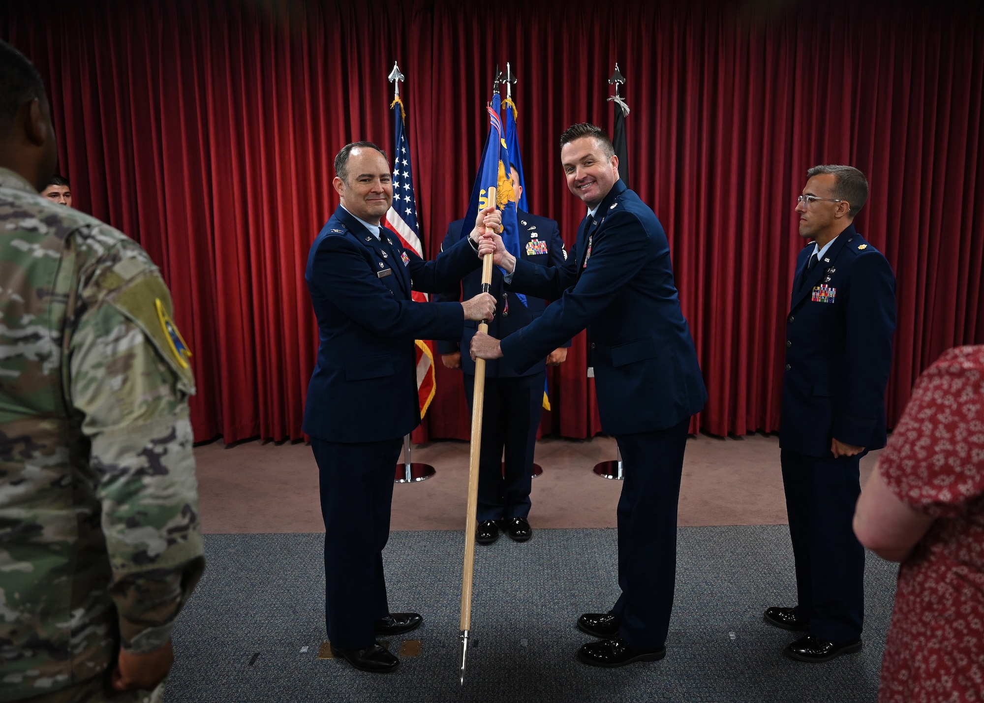 A man passes flag to another man.